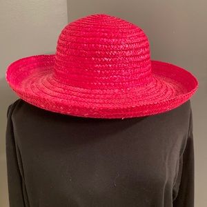 Pink straw hat with a wide brim